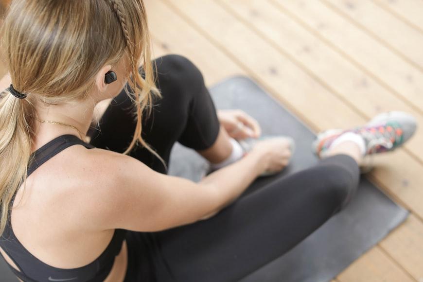 woman sitting on yoga mat