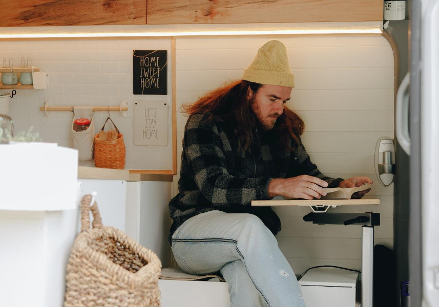 man reading in customized van