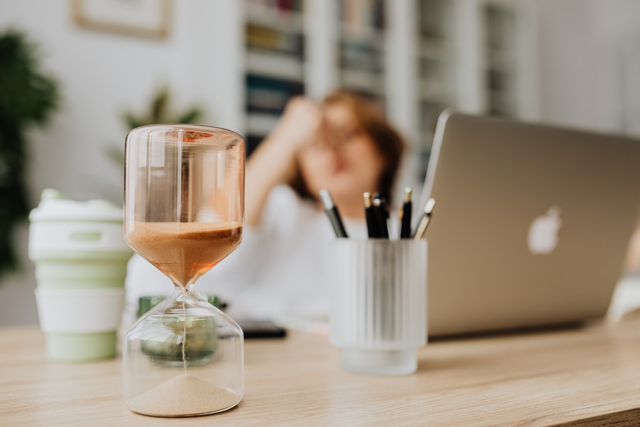 hourglass on wooden desk